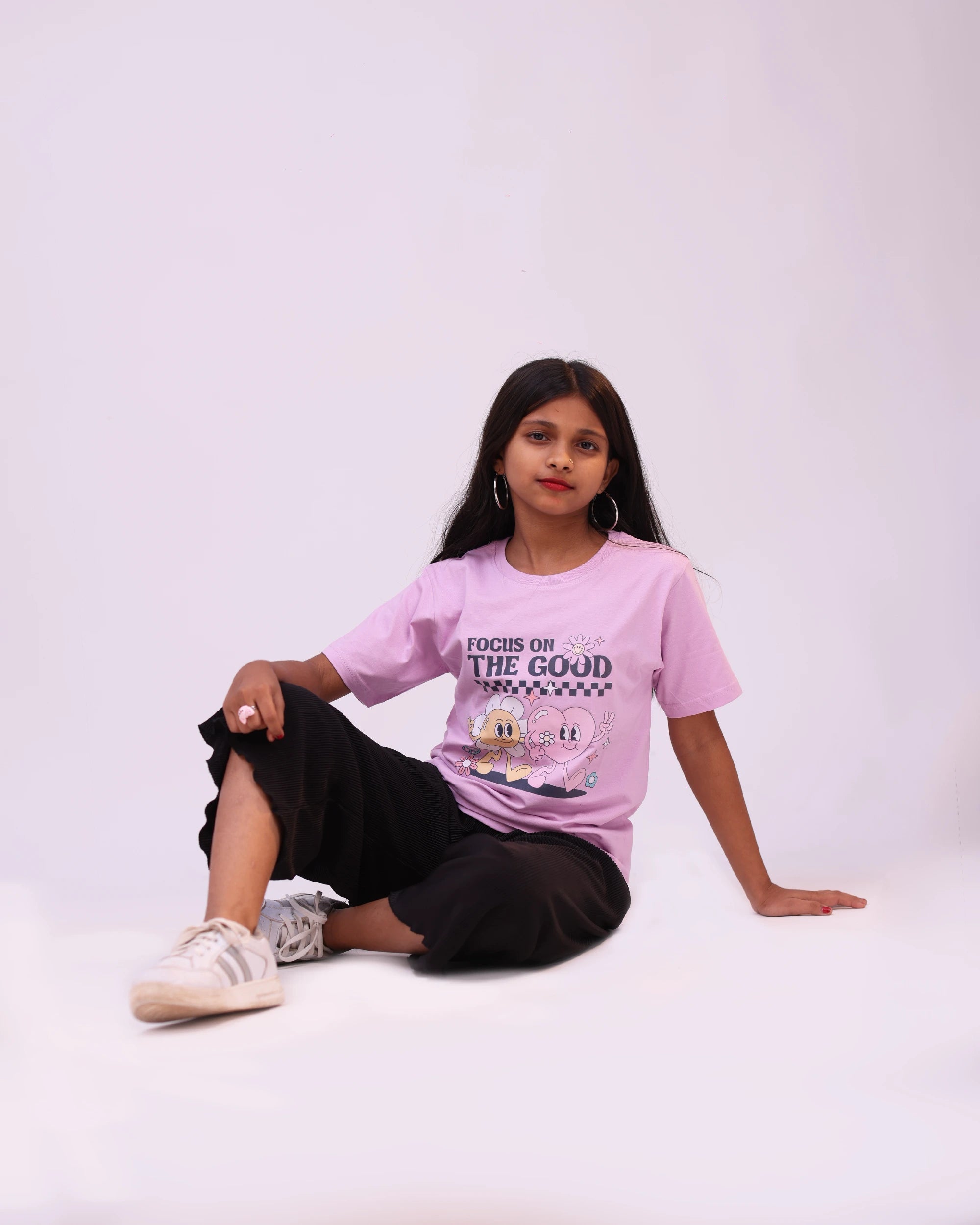 Kid joyfully wearing “Focus on the Good” tee—positive style in motion for boys & girls