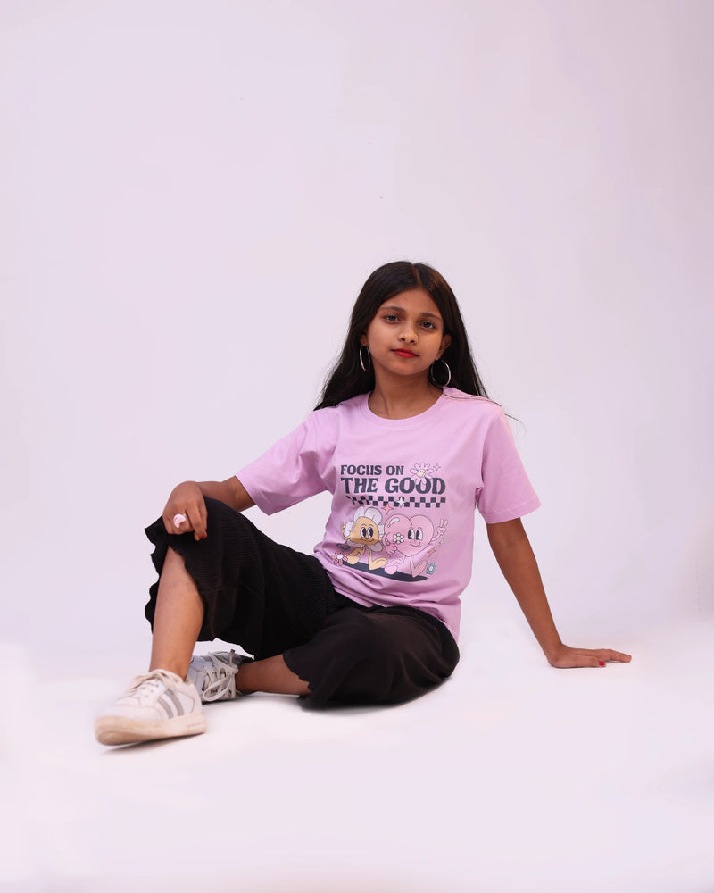 Kid joyfully wearing “Focus on the Good” tee—positive style in motion for boys & girls