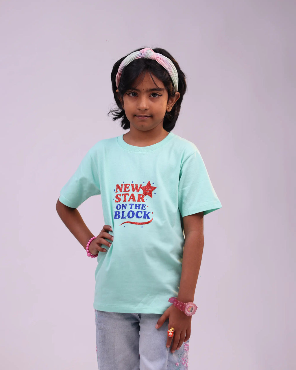 Close-up of “New Star on the Block” print on soft mint cotton tee