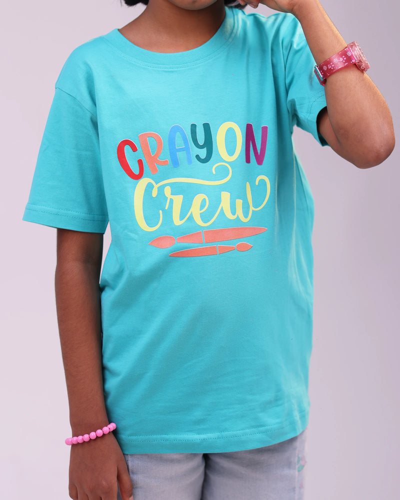 Direct view of “Crayon Crew” kids tee – flat lay showing colorful crayon design on soft cotton