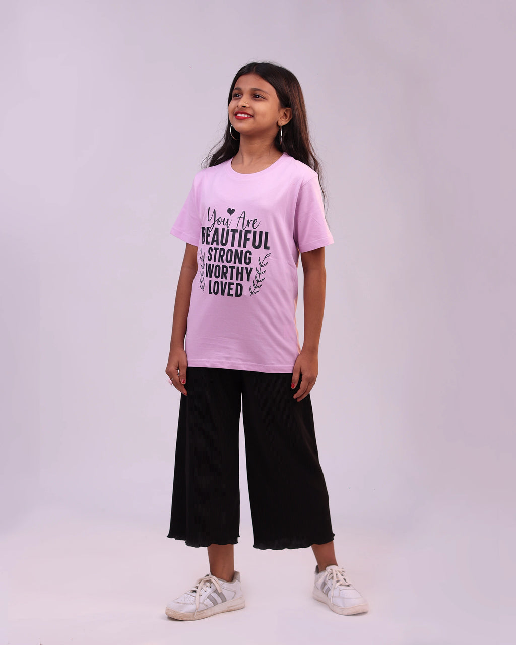 Kid joyfully wearing affirmations tee—lifestyle shot capturing positive energy