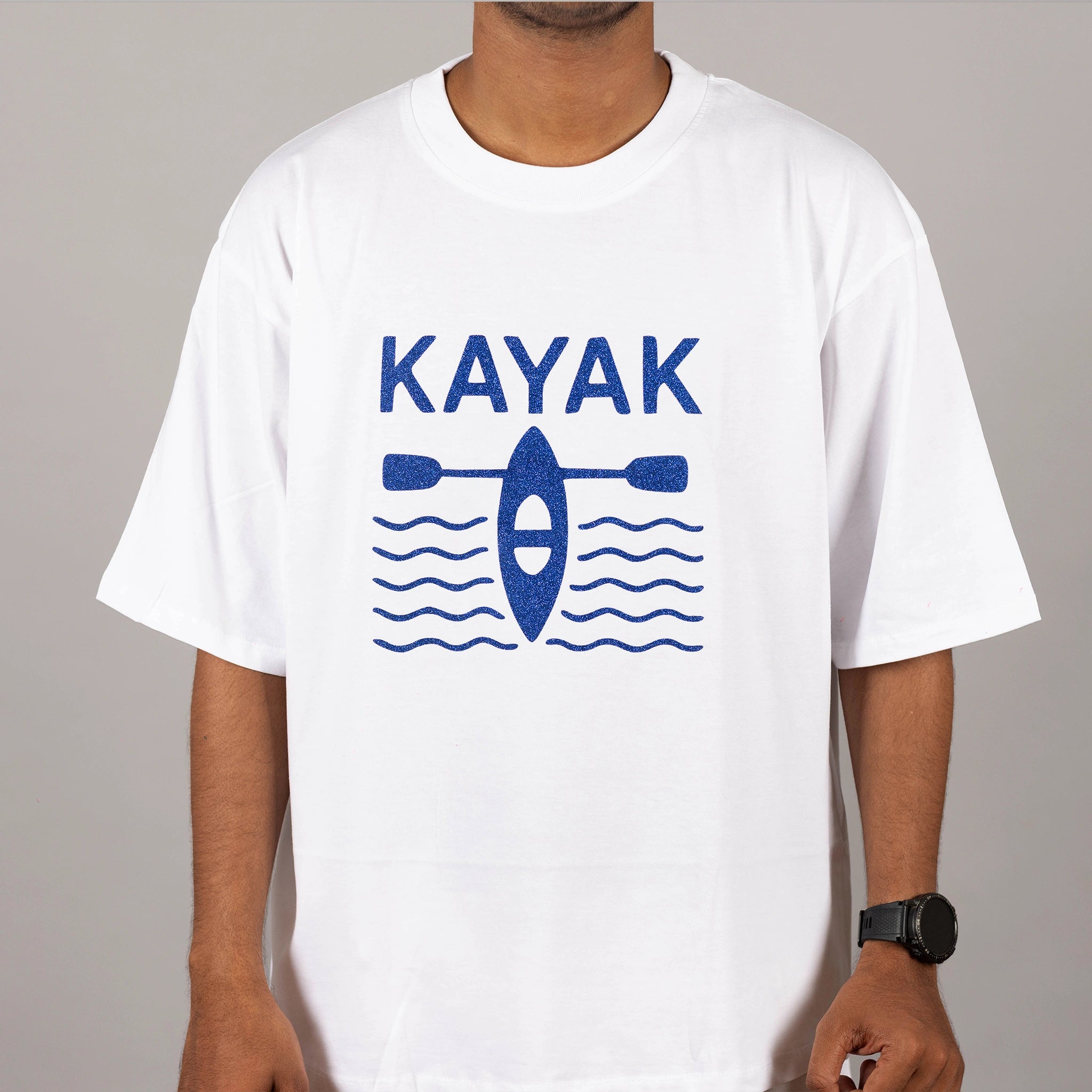 Side profile of white “Kayak” tee showing fit and the full view of design