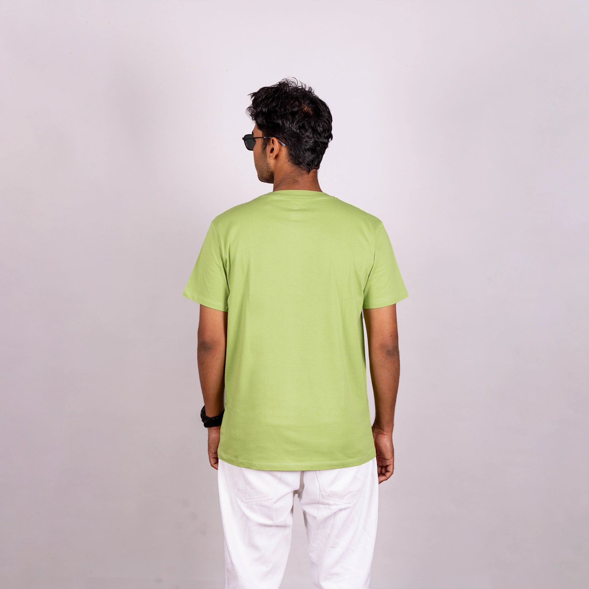 Back view of kiwi green tee showcasing smooth finish and relaxed silhouette