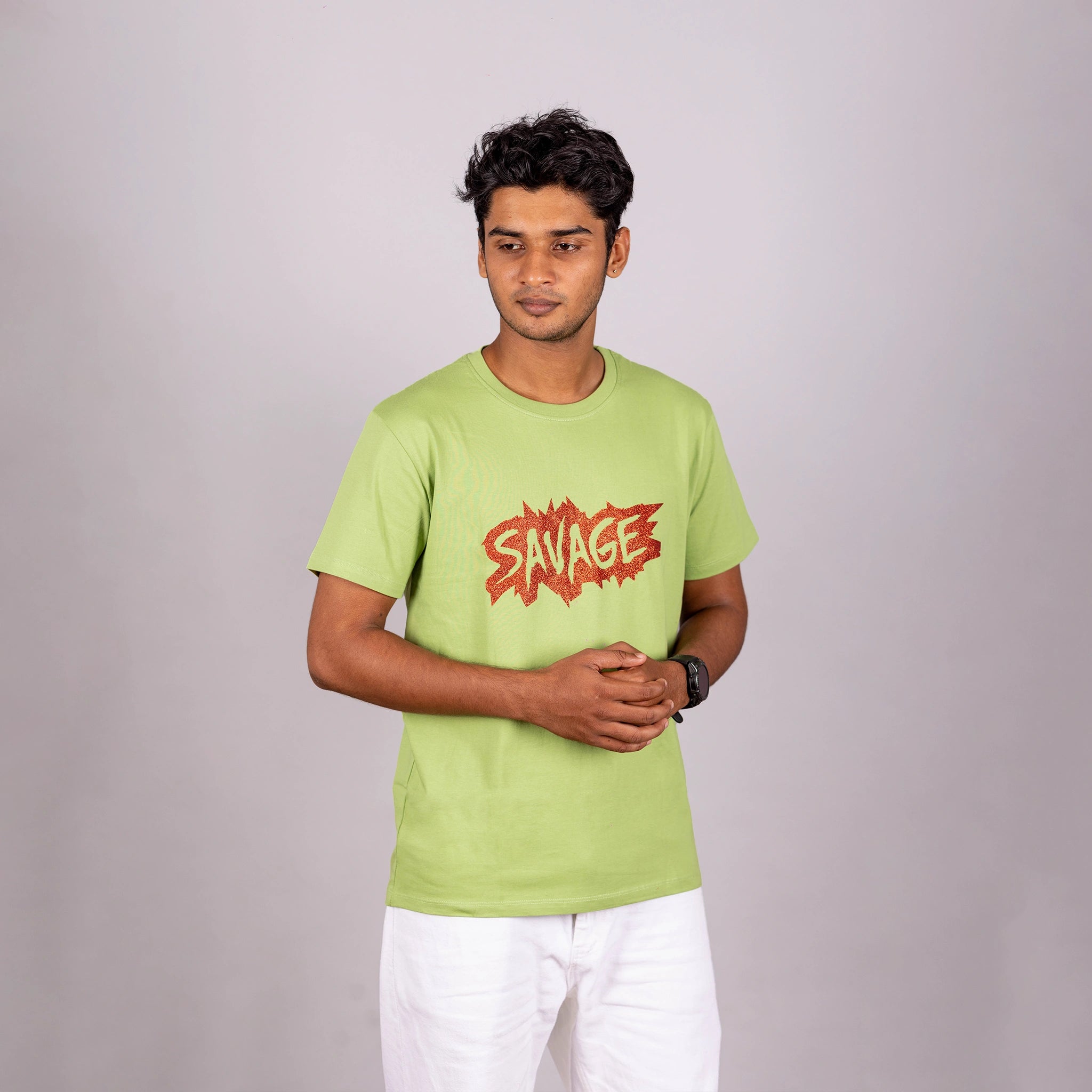 Man walking in kiwi green Savage tee—confidence and movement captured in an urban moment