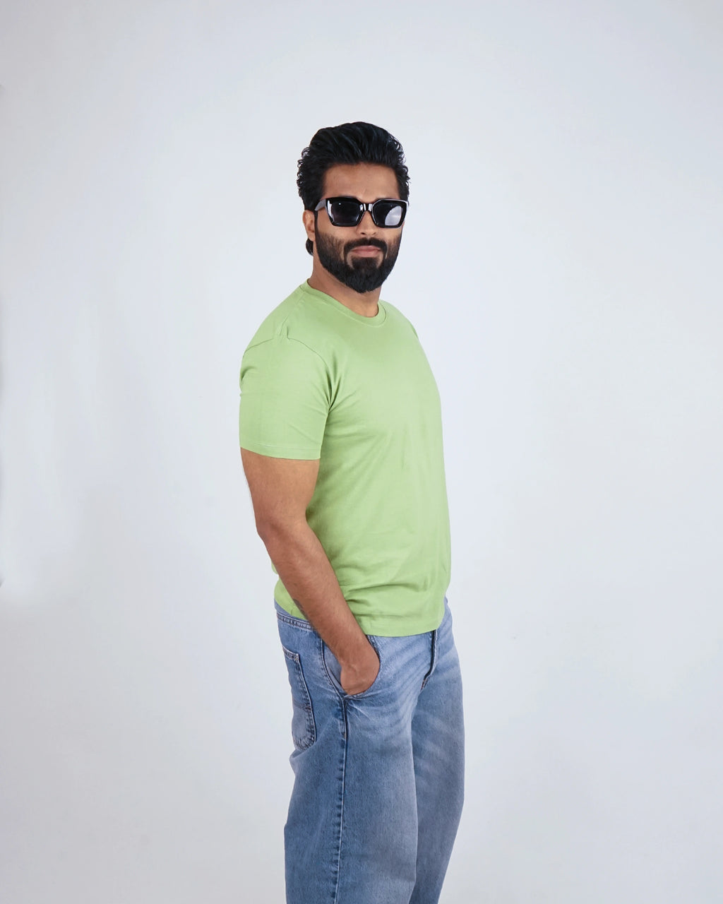 Man wearing Kiwi Green round neck tee for men, styled casually with chinos