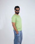 Man wearing Kiwi Green round neck tee for men, styled casually with chinos