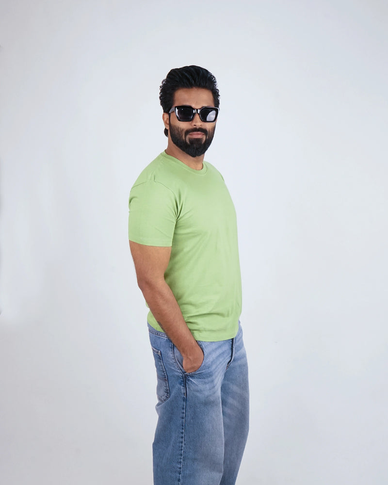 Man wearing Kiwi Green round neck tee for men, styled casually with chinos