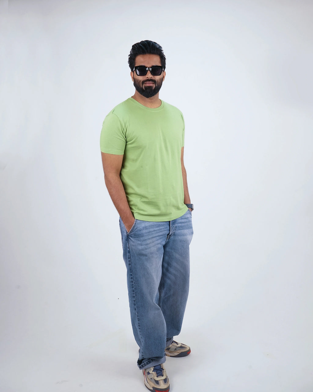 Man walking in Kiwi Green round neck tee for men, casual confidence and modern ease