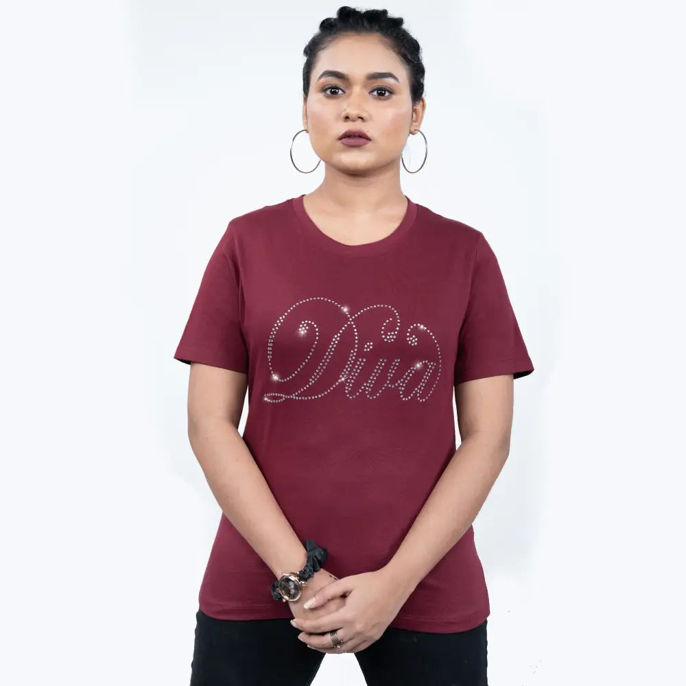 Woman wearing maroon “Diva” tee adorned with rhinestone lettering—confidence meets chic