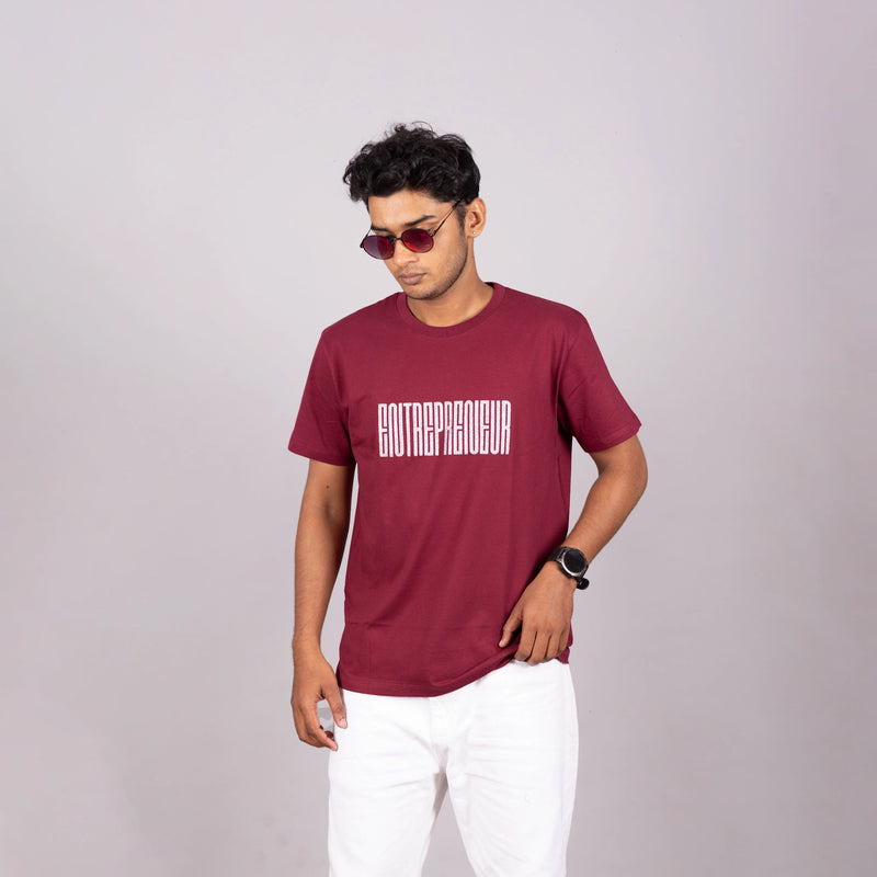 Close-up of bold “Entrepreneur” typography and soft fabric texture on maroon tee