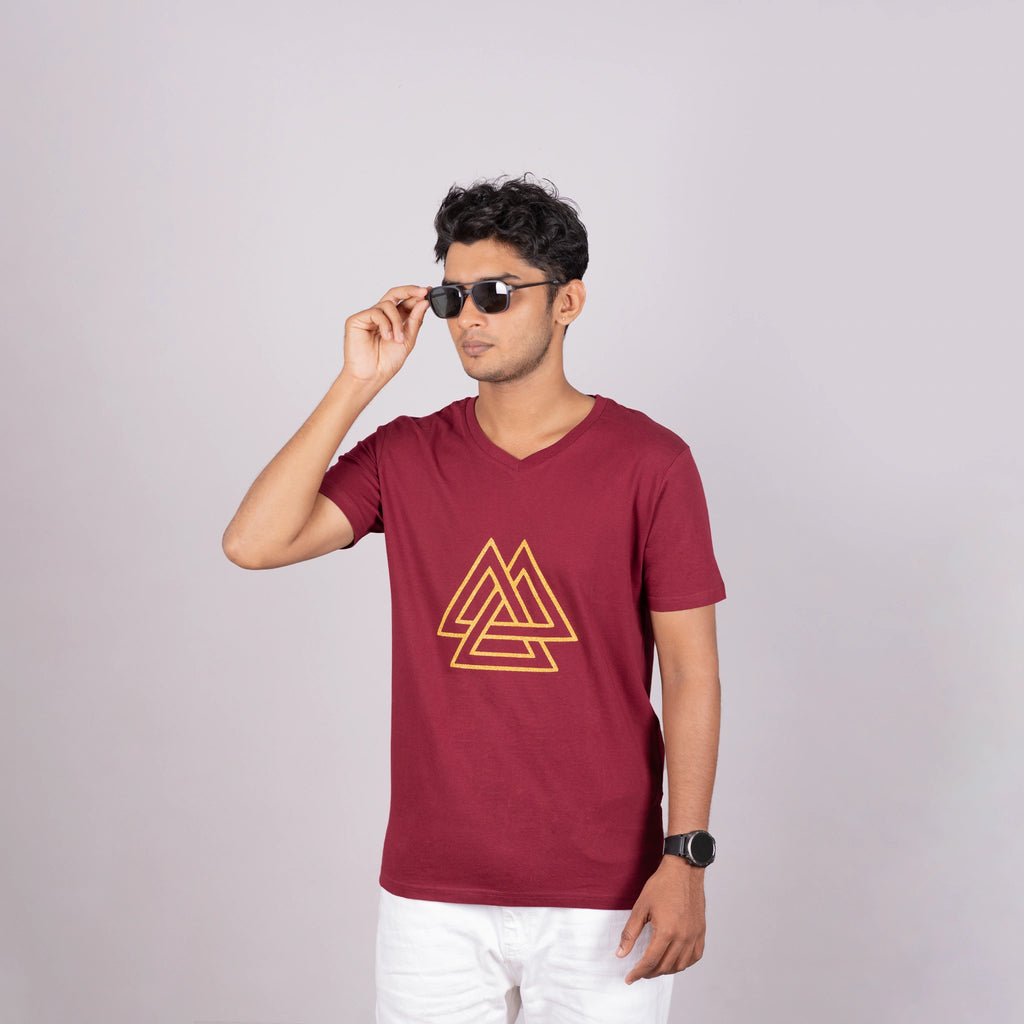 Side view of the maroon logo tee showing relaxed fit and metallic triangle detail