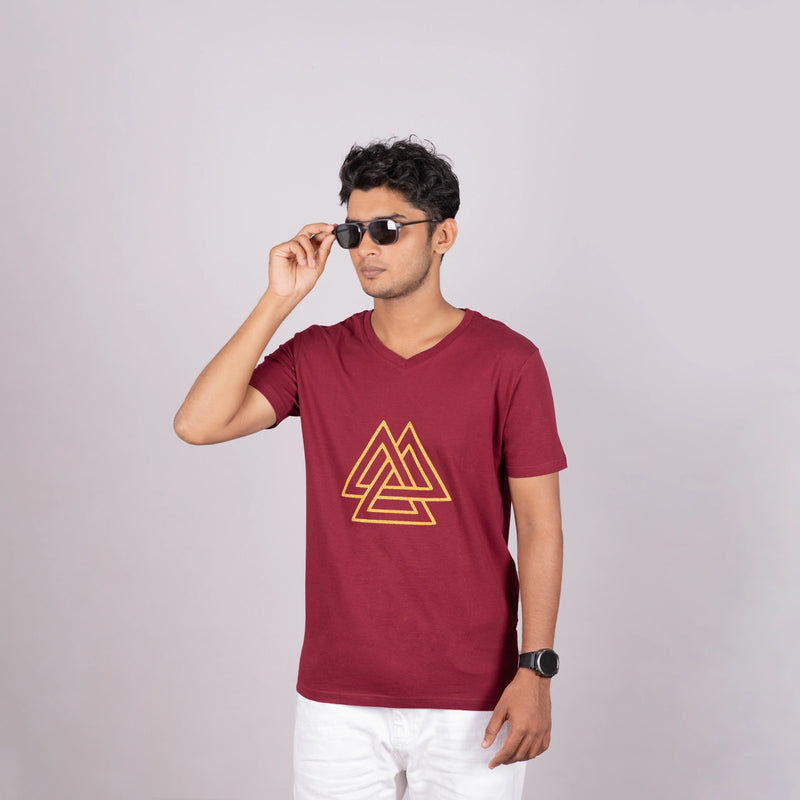 Side view of the maroon logo tee showing relaxed fit and metallic triangle detail