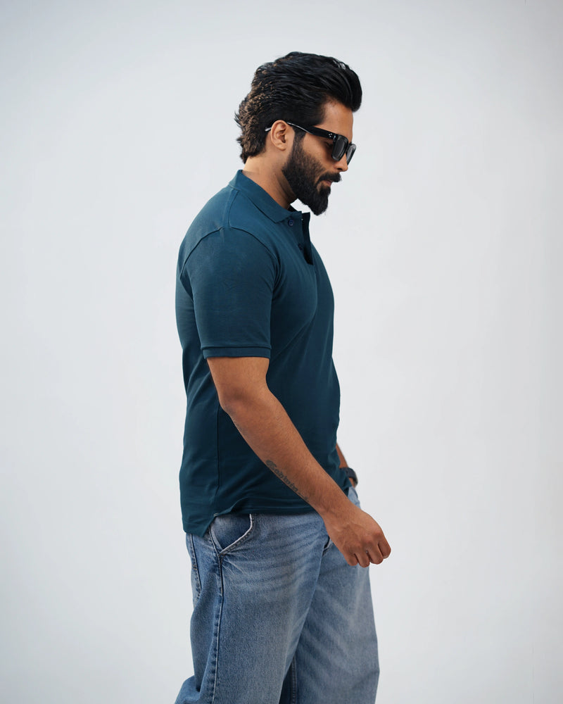 Back moving view of midnight teal polo highlighting smooth finish and clean silhouette