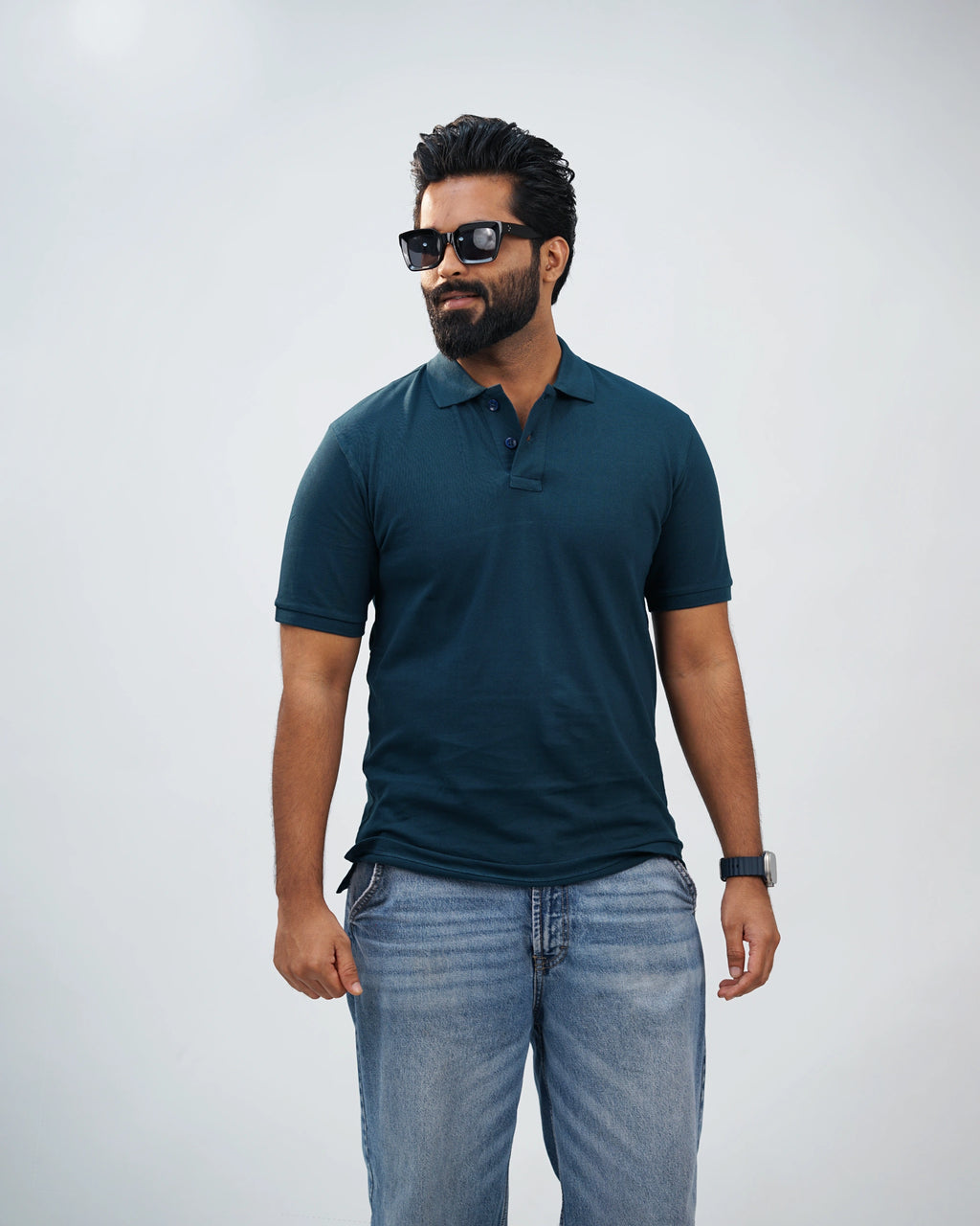Close-up of midnight teal polo showcasing fine stitching, collar detail, and premium fabric