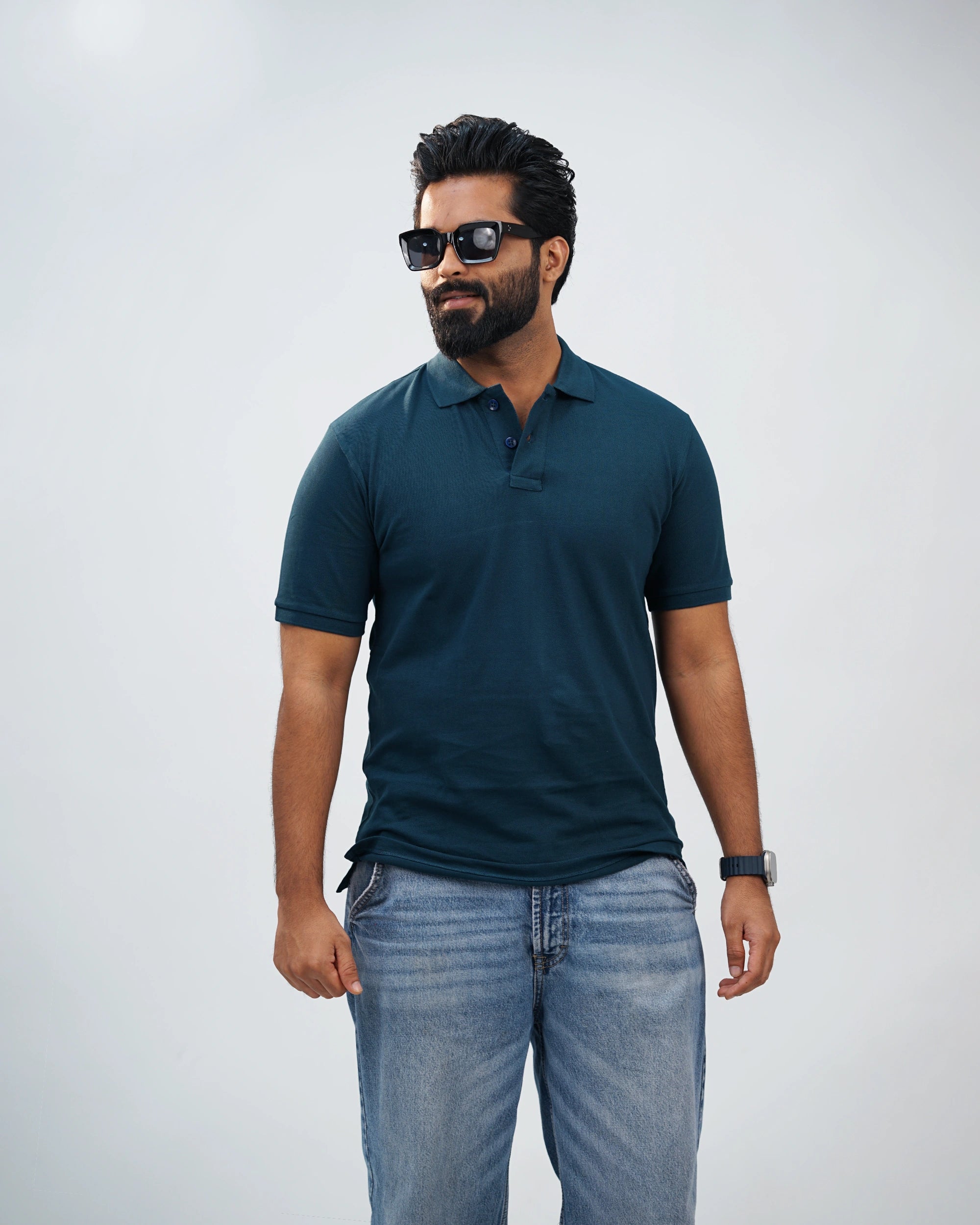 Close-up of midnight teal polo showcasing fine stitching, collar detail, and premium fabric