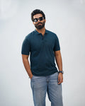Man wearing midnight teal polo with chinos—effortless sophistication in casual style