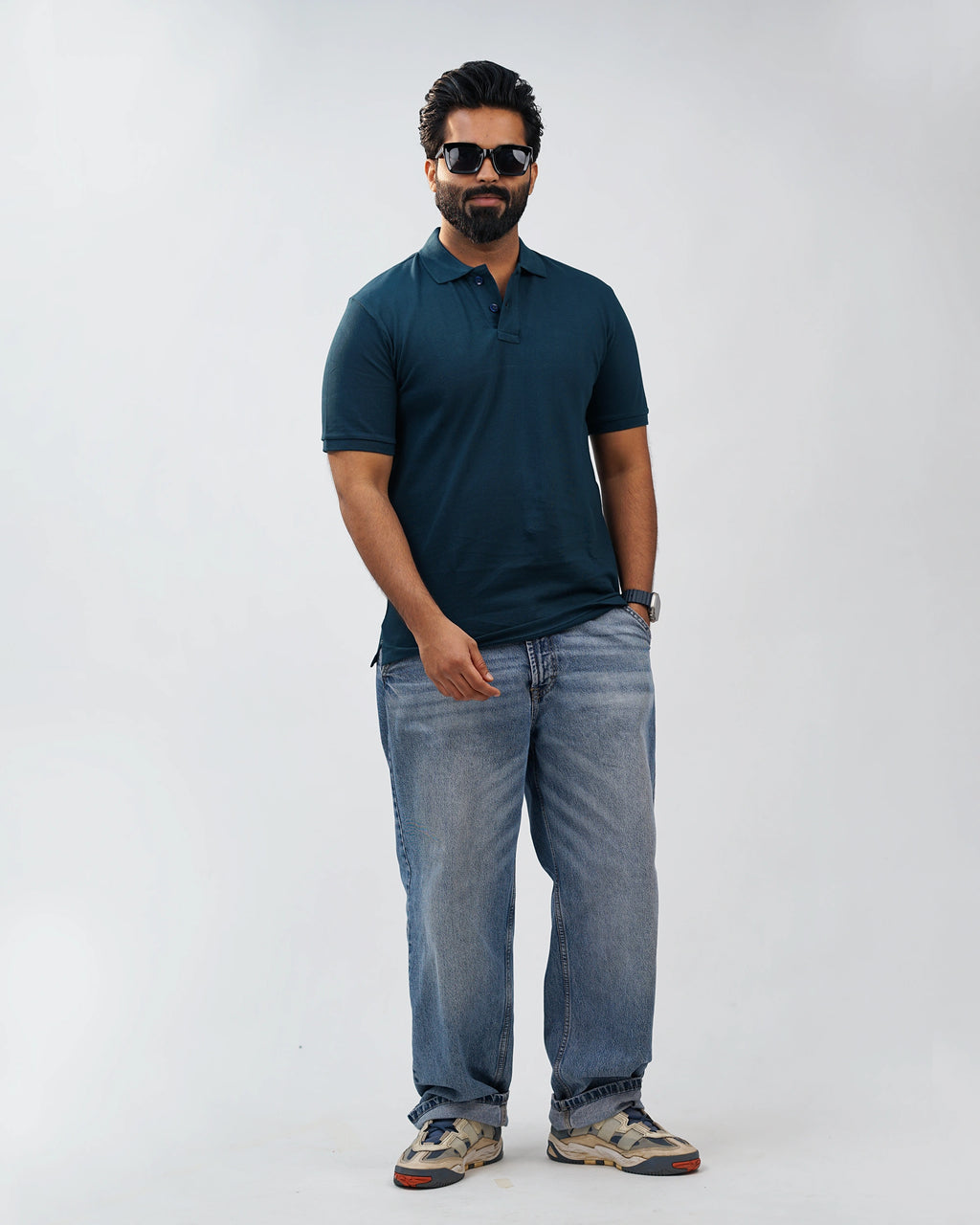 Side angle of the midnight teal polo emphasizing relaxed fit and textured cotton