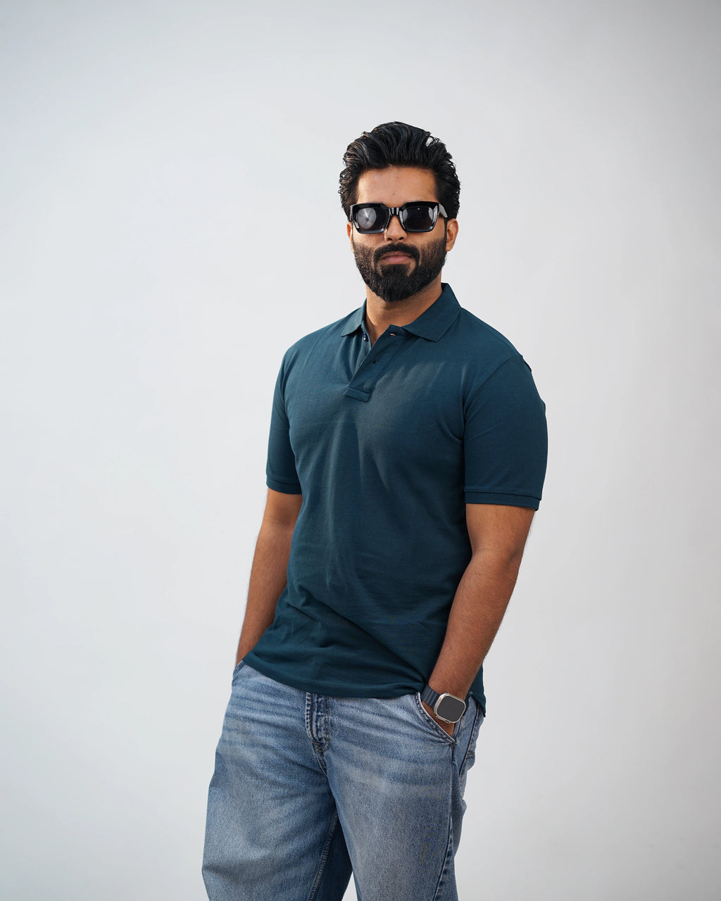 Man walking outdoors in midnight teal polo—capturing comfort, breathable cotton, and daily motion