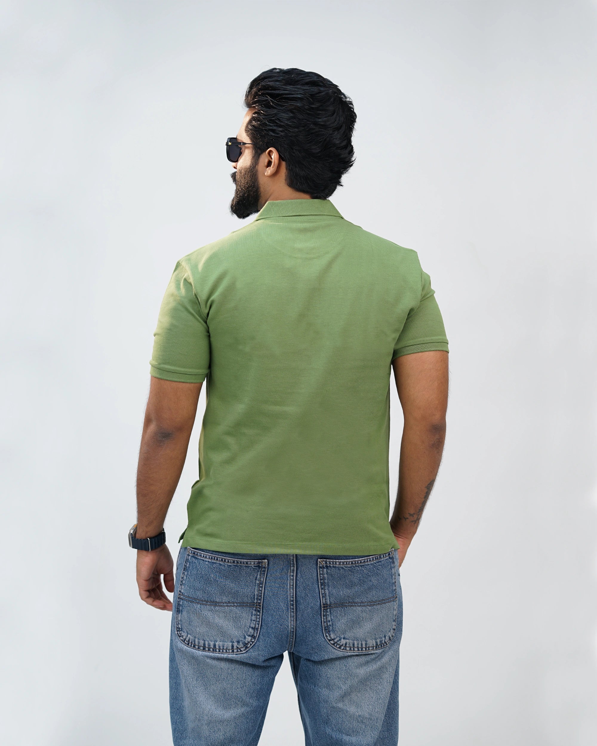 Back view of moss green polo tee—clean lines and airy feel for everyday comfort