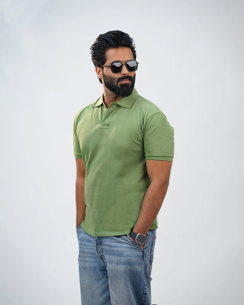 Side profile of moss green polo tee showing relaxed fit and smooth cotton drape