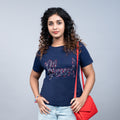 Woman wearing navy blue “Blessed” tee styled with chic trousers—casual-glam gratitude