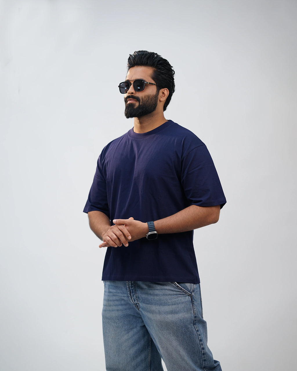 Man dressed casually in navy oversized tee—laid-back comfort that fits every mood