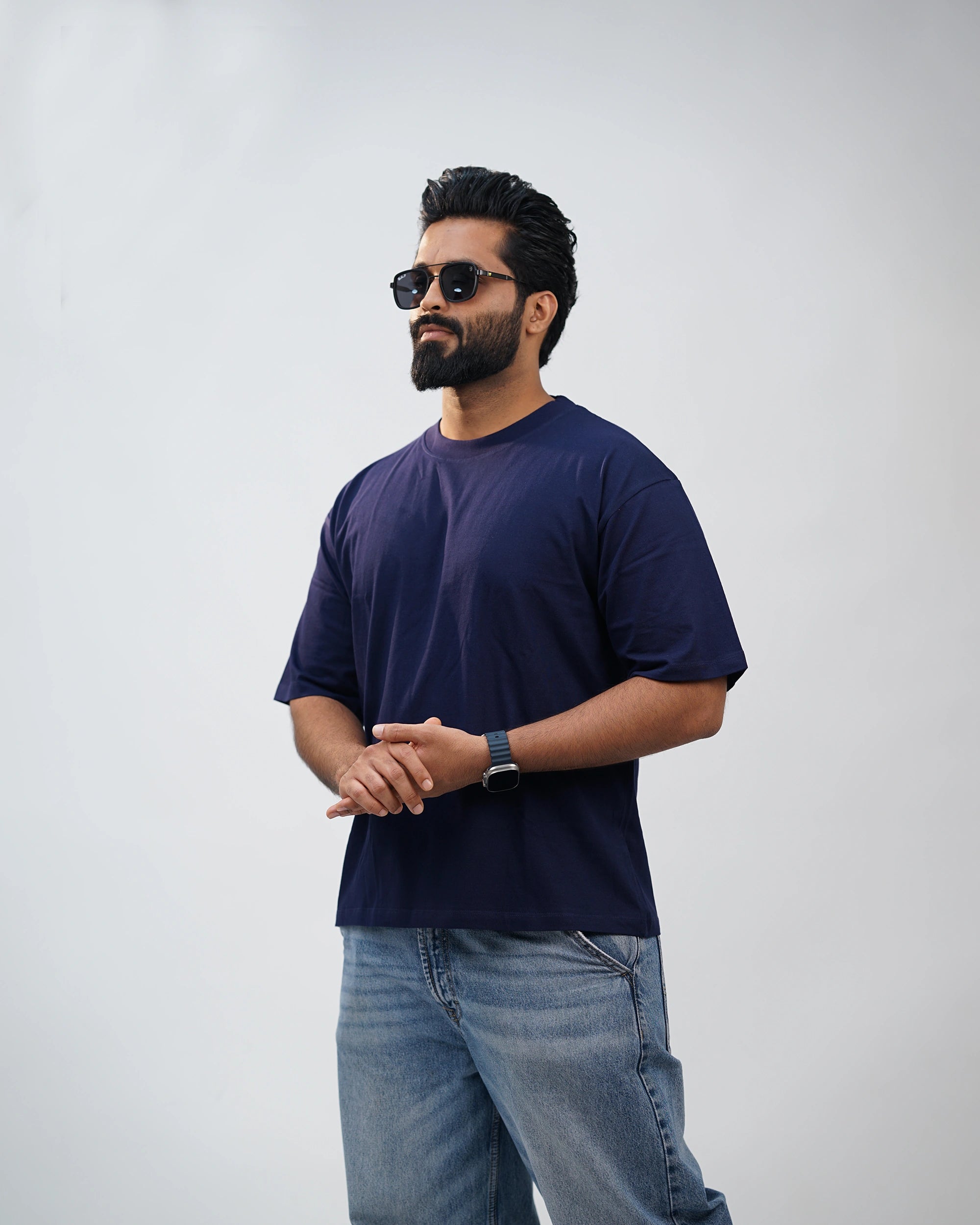 Man dressed casually in navy oversized tee—laid-back comfort that fits every mood