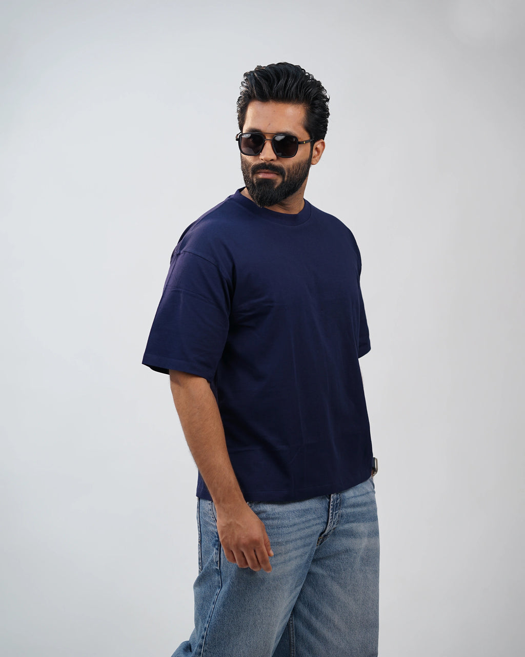 Man walking outdoors in navy oversized tee—urban comfort meets movement-ready style