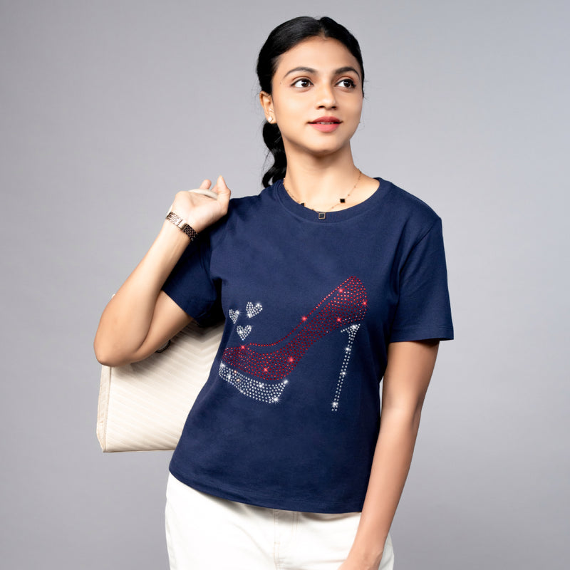 Close-up of navy blue “Party Shoe” tee showcasing glitter shoe print detail on soft cotton fabric