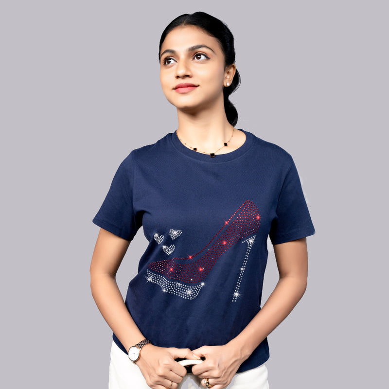 Woman wearing navy blue “Party Shoe” tee styled with heels—playful glam meets street-ready confidence