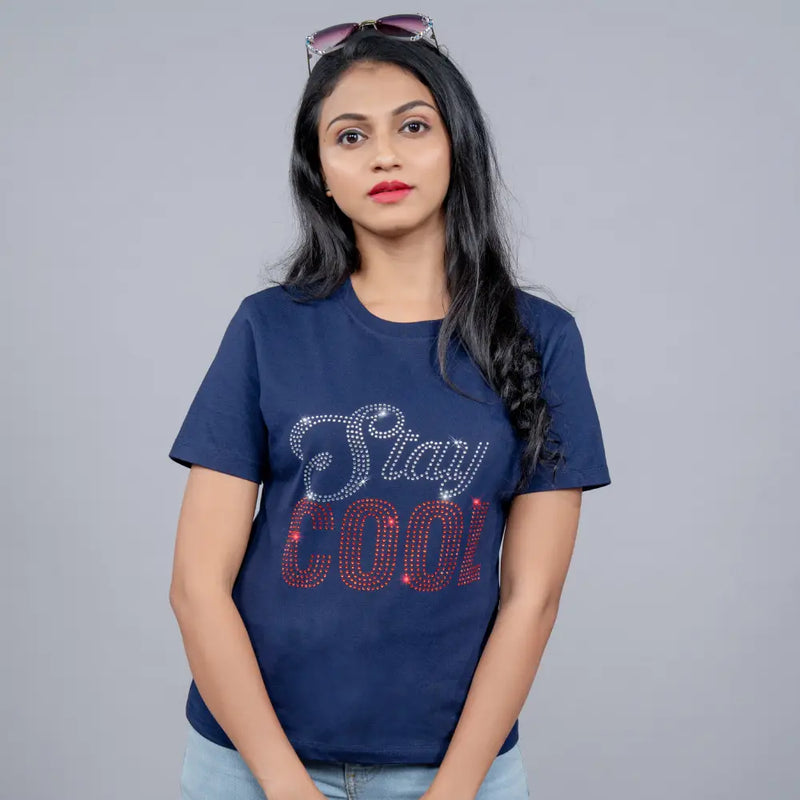 Woman in navy blue “Stay Cool” tee styled with white trousers—cool confidence mood