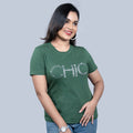 Woman wearing olive-green "Chic" tee with rhinestone lettering, styled with denim — refined cool