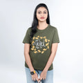 Woman wearing olive-green “Merci” tee paired with chic trousers—elevated casual mood