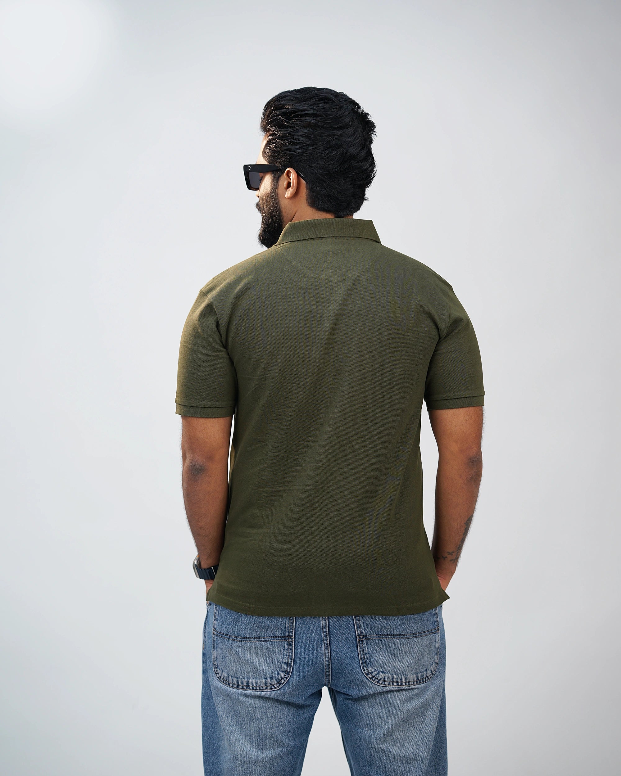 Back view of olive green polo tee showcasing clean silhouette and premium cotton finish