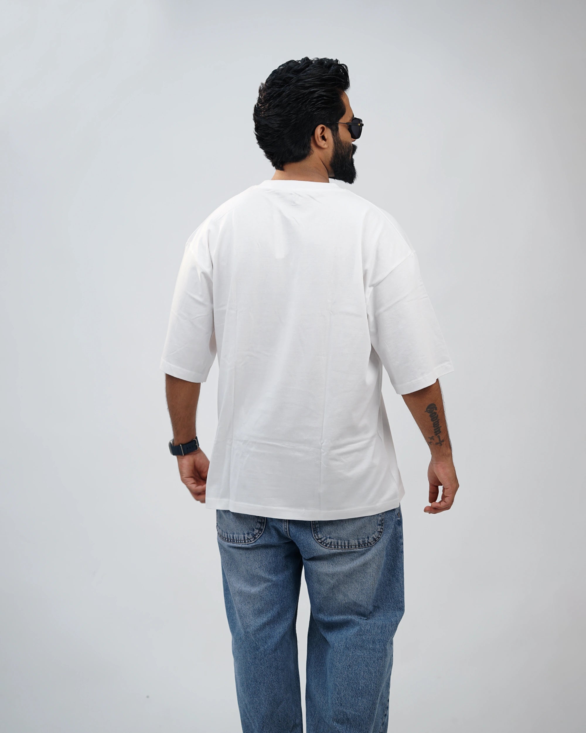 Back view of oversized white tee showcasing clean silhouette and soft cotton texture