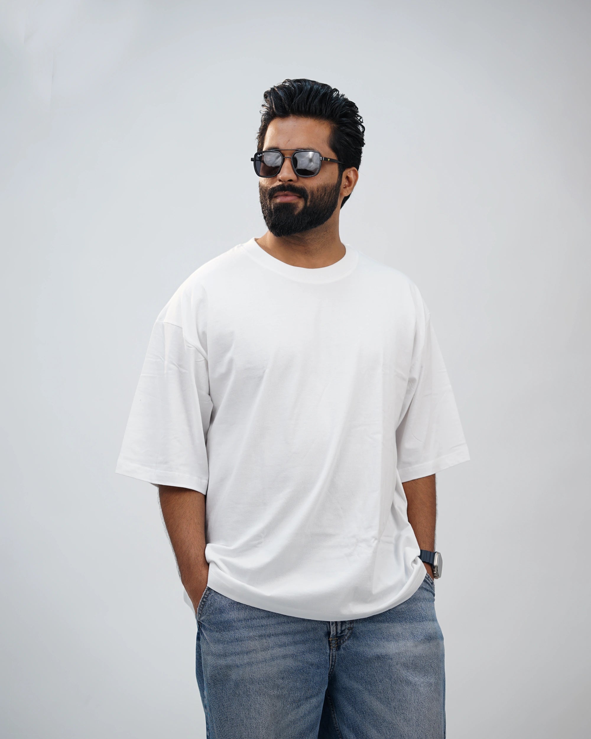 Side profile of oversized white tee for men—dropped shoulders and flowy fabric