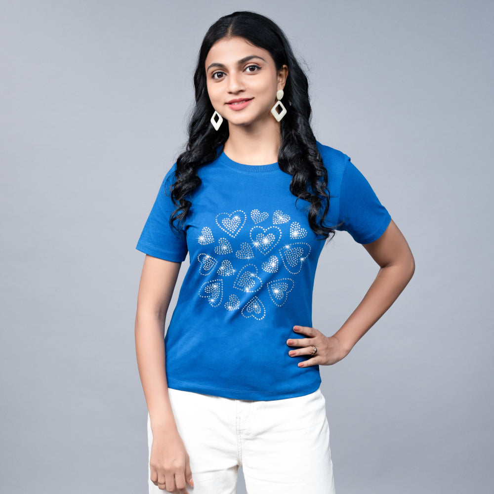 Woman wearing the royal blue “Hearts” tee with stylish bottoms—effortless glam meets statement love