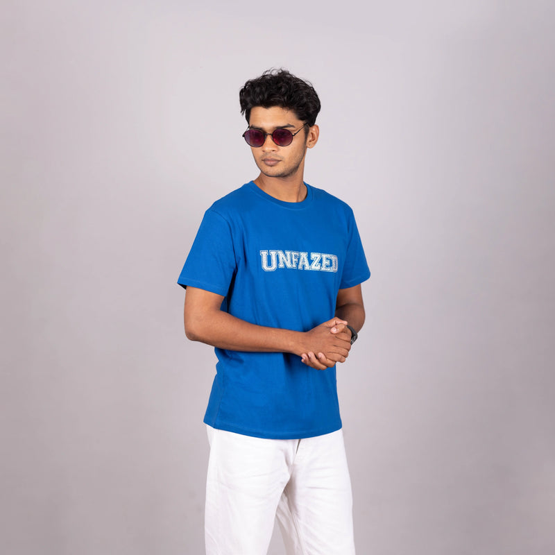 Man wearing royal blue “UNFAZED” tee with glitter print—bold, confident streetwear in India
