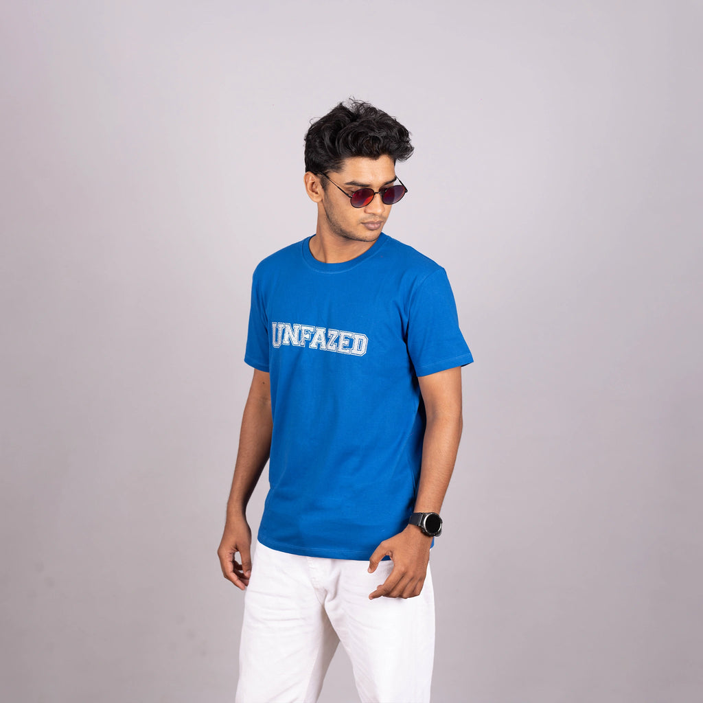 Side view of royal blue UNFAZED tee showing relaxed fit and shimmering graphic from the side