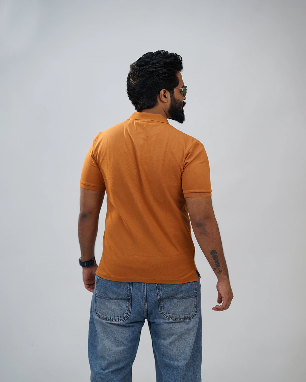 Back view of terracotta polo tee for men, classic half sleeve polo shirt in cotton blend.