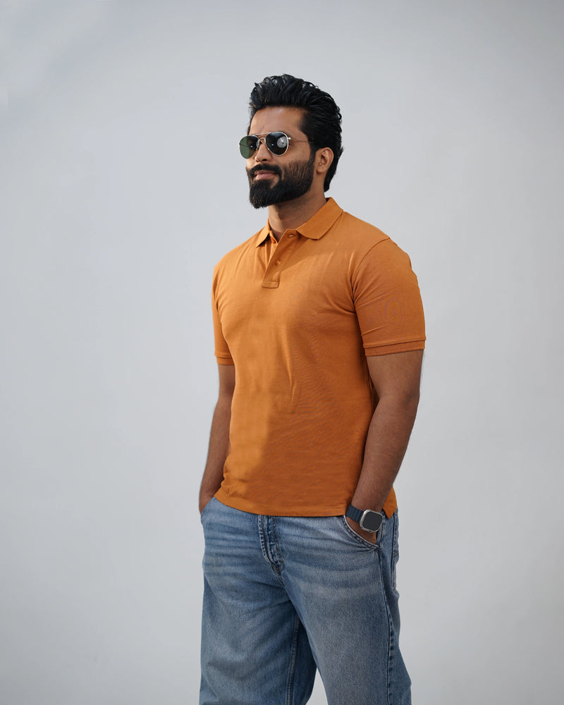 Terracotta polo t-shirt for men close-up shot, soft cotton fabric with classic collar design.