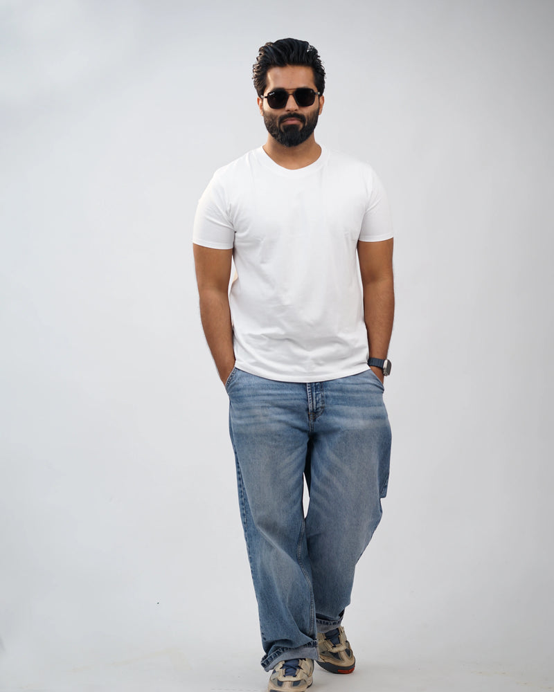 Man wearing classic white crew-neck tee for men, front view, styled with blue jeans