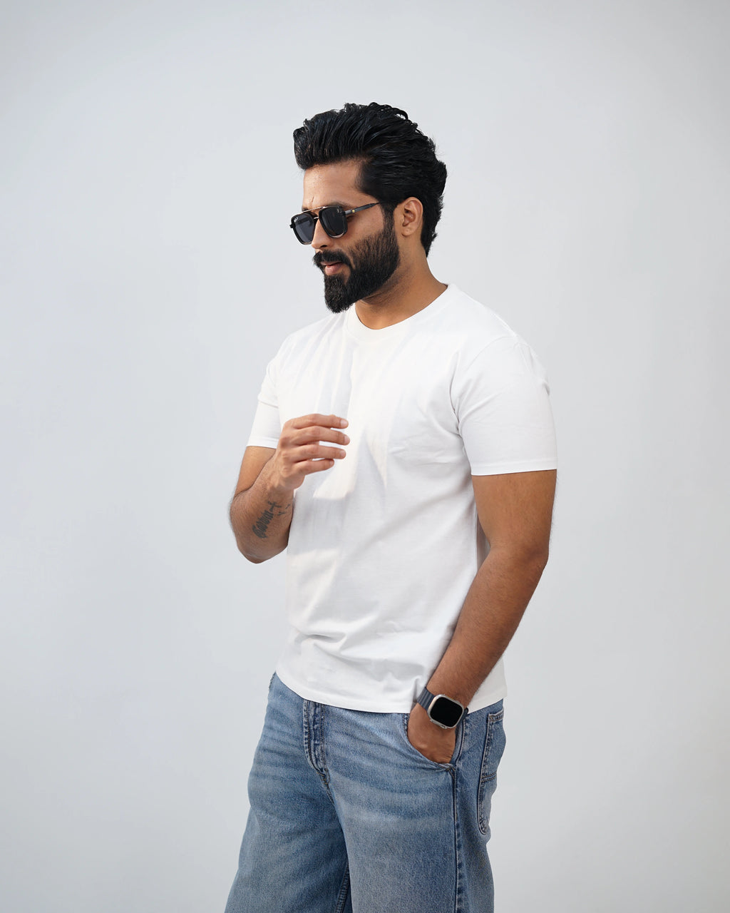 Man in white crew-neck tee outdoors—casual, versatile styling with urban confidence