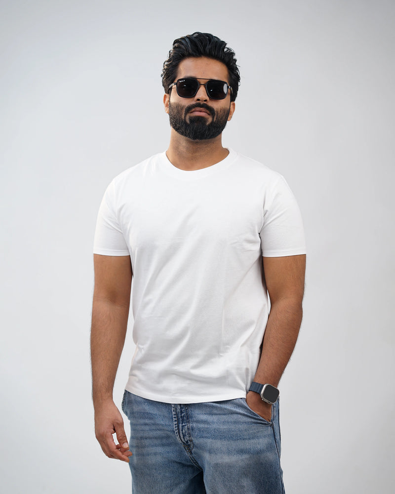 Man in white crew-neck tee, side pose showcasing clean silhouette and relaxed fit