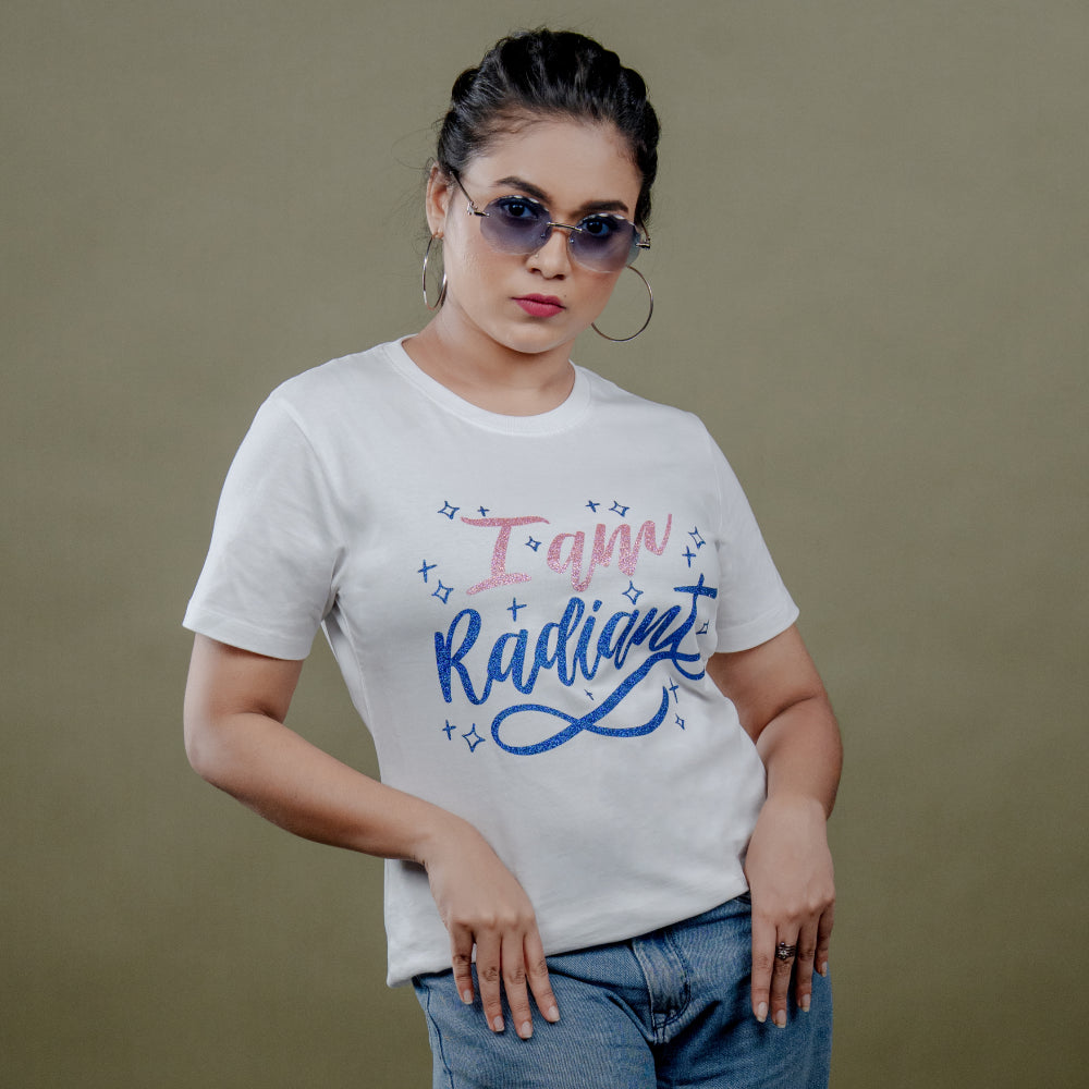 White women’s tee front close-up with glitter ‘I Am Radiant’ print in pink and blue
