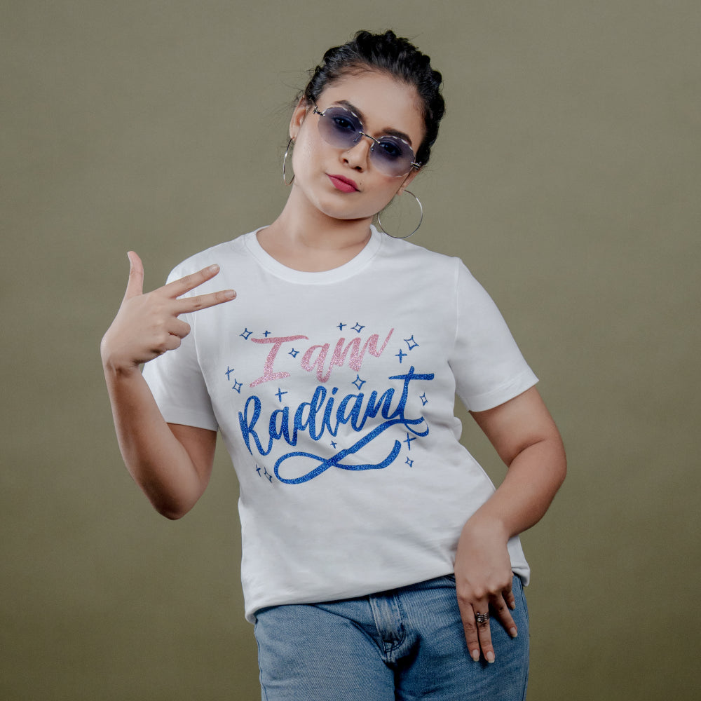 Angled side view of white ‘I Am Radiant’ tee on model showcasing relaxed fit and shimmering text